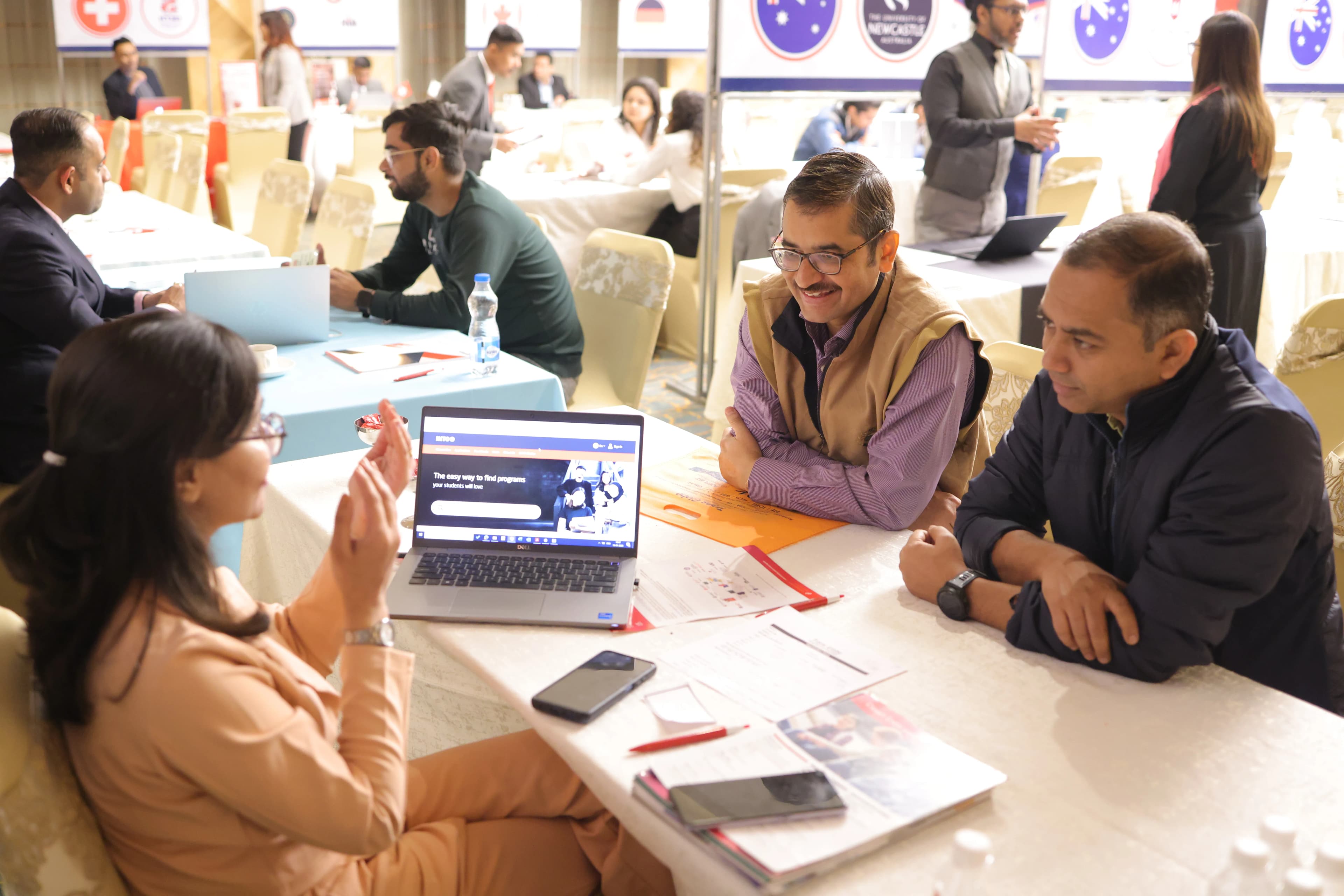 Student interacting with university representatives at Global UniExpo